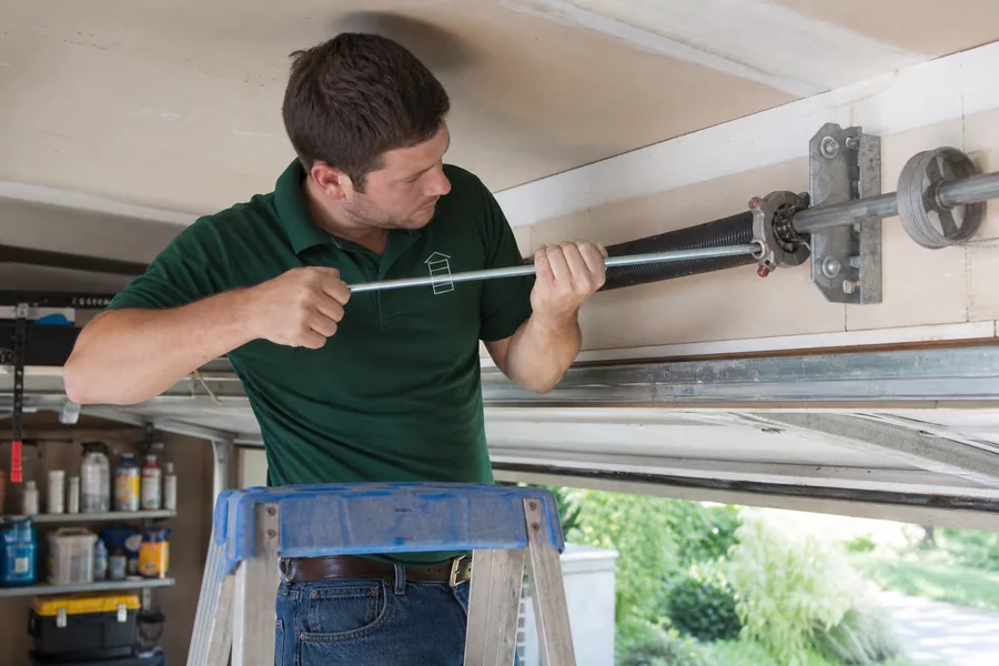Rescue Garage Doors technician replacing a broken torsion spring in Corpus Christi, TX